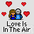 Pixel art of two figures embracing with red hearts floating around them, text reads 'Love Is In The Air' below.