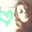 A pixelated image of a person with brown hair and closed eyes, accompanied by a green heart symbol on the left side.