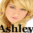 Pixelated image of a person with light brown hair and closed eyes, wearing a dark top with visible text below.