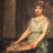 Pixelated static image of a seated figure in a light-colored sleeveless dress against a dark brown background.