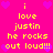 A bright pink background with yellow text reading "i love justin he rocks out loud!!!" repeated twice, surrounded by purple heart symbols.