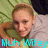 Pixelated image of a person with light brown hair wearing green clothing, lying on a patterned surface with blue text at the bottom.