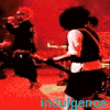 A four- shows a person with red hair in various poses: dancing, holding a microphone, and drinking from a bottle under red lighting