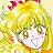 Pixelated image of a character with long yellow hair, a pink bow, and a white outfit with brown accents, set against a light yellow background.