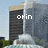 Pixelated image of a building with a fountain, displaying two different text overlays in sequence.
