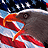 Pixelated close-up of a bird's head with a red beak, gray feathers, and a white stripe above the eye against a blue and white background.