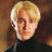 Pixelated image of a person with blonde hair and a black turtleneck, alongside green pixelated text reading "so this is what evil looks like......." and "evil is HOT" on white and gray backgrounds.