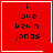 Red square icon with black text "i love kevin jonas" and white border; top-right corner has a small white heart, bottom-right corner has a small white starburst.