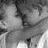 Grayscale pixelated image of a figure with dark hair and light clothing, partially obscured by low resolution.