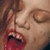 Pixelated close-up of a person's face with closed eyes and red lips, likely from an animated film or cartoon source.