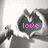 A grayscale image of hands forming a heart shape with the word 'love' in pink text inside, displayed