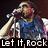 A pixelated image of a person singing into a microphone with 'Let It Rock' text below, wearing a blue shirt against a dark background.