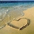 Beach scene with heart drawn in sand, water washing over it, and red text reading 'My heat is getting washed up' in four