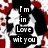 Black-and-white dog with red and white patterned background; text reads "I'm in Love wit you" on black rectangular blocks.