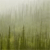 A pixelated static image with a gradient background transitioning from light gray at the top to dark green at the bottom, featuring vertical pixel clusters resembling abstract shapes.