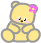 Two yellow teddy bears with pink cheeks sit side-by-side, each wearing a pink flower on their head; the left bear has a slightly different eye expression than the right.