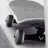 Static grayscale image of a skateboarder performing a trick on a ramp with visible wheels and deck details.