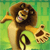 Pixelated lion with brown mane and tan body stands against green background, holding a golden crown in its right paw and a black ring in its left paw, mouth open with pink tongue visible.