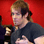 A pixelated image of a person with light brown hair in a ponytail wearing a black shirt, positioned against a red background with text reading "I want YOU!" on the right side.
