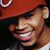 A pixelated image shows a person wearing a red cap with white trim and a red jacket over a white shirt, displaying two distinct facial expressions side by side.