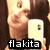 A pixelated image shows a person holding a white smartphone with a small screen icon, against a dark background, with the text 'flakita' in bold white letters on a black bar at the bottom.