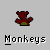 Pixelated red bear icon with green base and raised arms above text reading Monkeys Will Take Over The World on gray background.