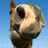 A pixelated image of a horse's head against a blue sky, with a yellow displaying orange text on the right