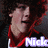 A pixelated image of a person with curly dark hair wearing a red and black shirt, with text below the head.