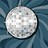 A circular pixelated icon with a light gray and white textured surface, set against a dark blue background with diagonal lines.