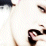 Pixelated static icon showing partial view of a person with dark hair and light skin tones, featuring visible facial features like eyes and mouth against a white background.