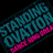 A pixelated promotional graphic for 'Standing Ovation' with text elements in pink, teal, and yellow on black and white backgrounds.