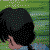 Pixelated character with black hair in a braid, light blue shirt, and green background, showing sequential facial expressions from side to front view.