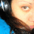 Pixelated close-up of a person's face with brown hair, light skin tone, and visible eye details against blue background.
