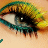 A close-up of a human eye with teal and yellow eyeshadow, featuring animated heart symbols that change position across frames.