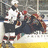 A pixelated image shows a hockey player in a dark uniform on ice, with a red displaying text on the right