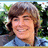 Pixelated image of a person with light brown hair and blue clothing against green foliage, next to yellow text on solid blue background.