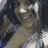 Pixelated static image of a figure with light skin tone, dark hair, and visible facial features including eyes, nose, mouth, and ears against a blurred background.