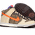 A pixelated sneaker with a beige and brown pattern, orange Nike swoosh, dark brown heel, and small red detail on top.