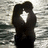 A pixelated black silhouette with a white star-shaped cutout against a gray and white striped background.