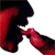 Pixelated red and black figure in profile view with mouth open, appearing to bite or interact with a red elongated object against a white background.