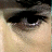 A split-frame contact sheet showing a close-up of an eye on the left and pixelated text reading "the butterfly effect" on the right against black background.