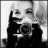 Black-and-white pixelated image of a person holding a camera, with two showing the flash firing