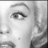 Monochrome pixelated close-up of a human eye with defined eyelashes and eyebrow, set against a light background with darker vertical elements.