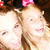 Two pixelated figures with light skin tones, brown hair, and pink accessories, positioned closely together in a static image.