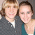 Two people pose together in a pixelated image with visible text at the bottom; one person wears a dark gray shirt and white undershirt, the other a teal top.