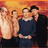 Pixelated group photo of four people on left, red background with text and symbols on right.