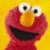 Elmo's face on yellow background with red text reading 'Elmo's A Pimp!' in showing slight facial pixel shift