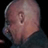 Static 48x48 pixel icon showing a close-up of a bald human head with visible ear and partial neck, rendered in low-resolution pixel art style against black background.
