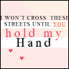 A four- displays a static image with animated heart symbols; text reads "I WON'T CROSS THESE STREETS UNTIL YOU hold my Hand" with "YOU" in orange and "hold my Hand" in red and black