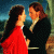 A split-screen image shows two couples in period attire and a red rose, with no visible motion.
